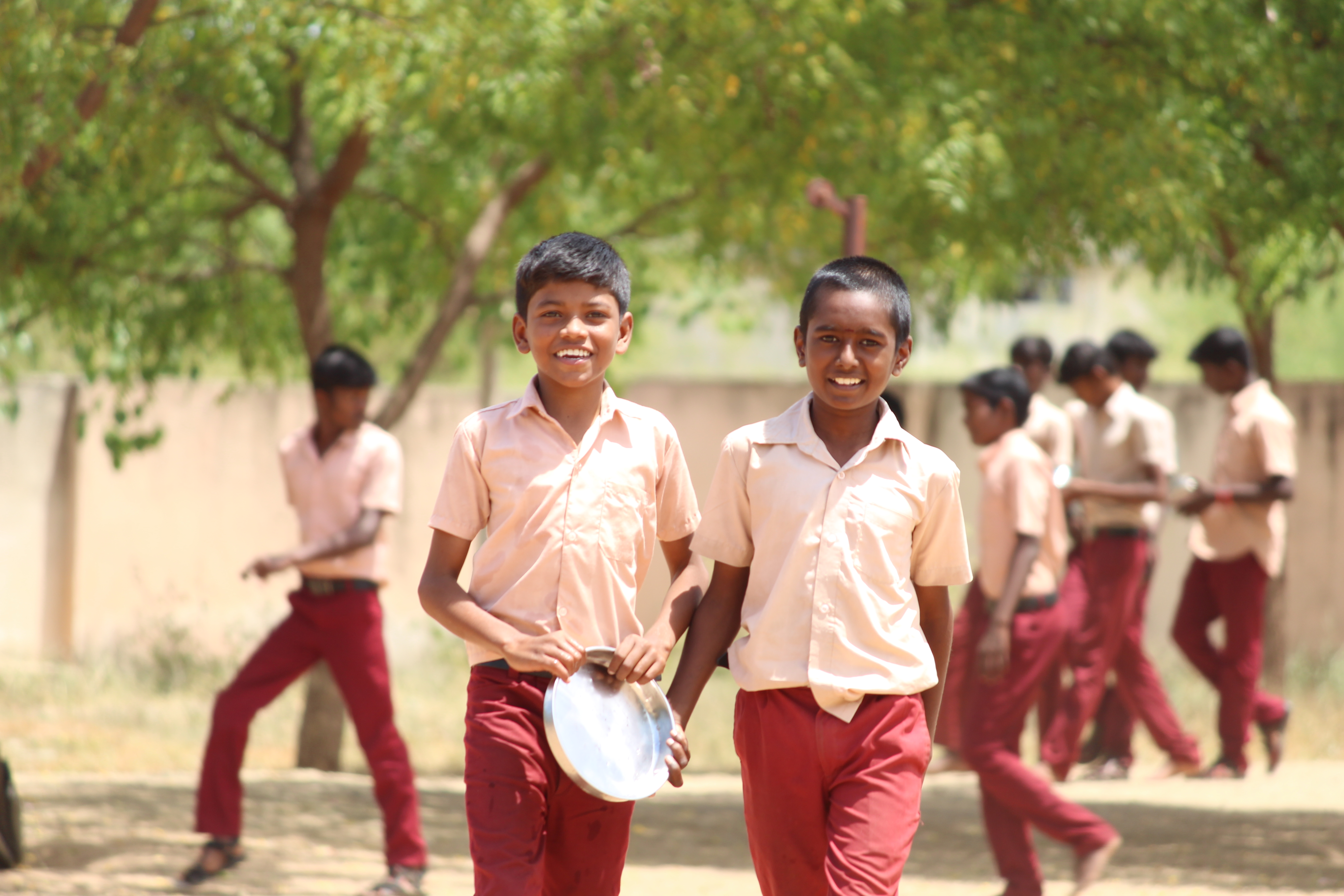 Two school students in India head to lunch break