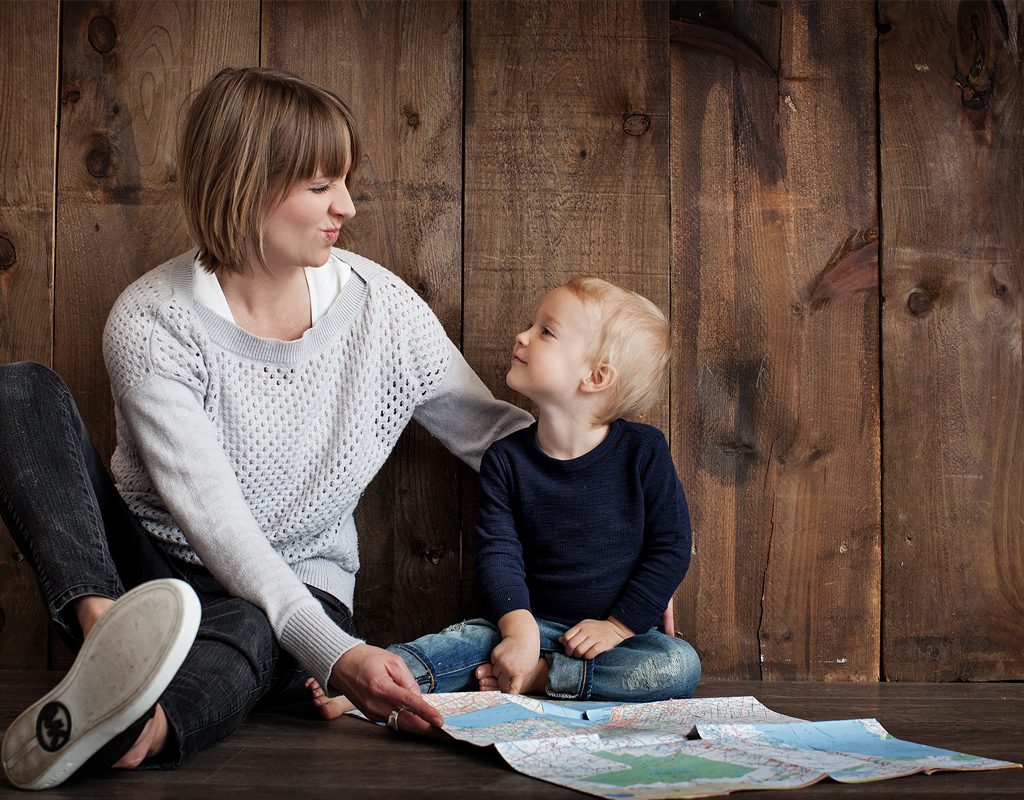 A mother reading a book to her young son