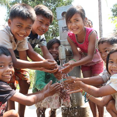 Children in Cambodia with a hand pump well