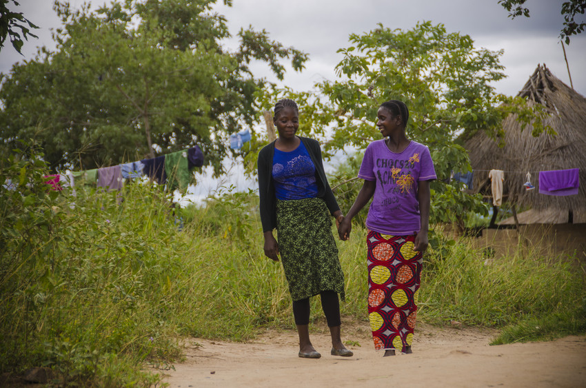 Sixteen-year-old Carol, left, walks and talks with her mother, Mavis, 29. Says Mavis, "Carol is committed to school. She does not fool around, and I teach her about the way a young lady should conduct herself. Carol aspires to become a teacher so she can take care of her parents.