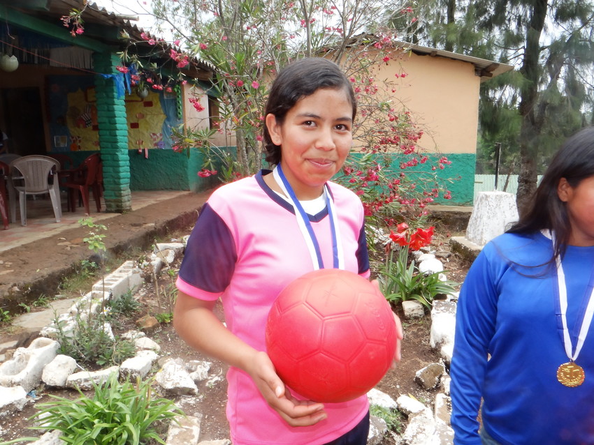 Kelin, 17 (second from left), is the captain of her school's girls' soccer team in rural Honduras. Before ChildFund donated unpoppable soccer balls to her school through One World Play Project's #PassTheHappiness campaign, she and her teammates used to have to borrow soccer balls from the boys just so they could play. Now, they're an award-winning girls' team in their area.