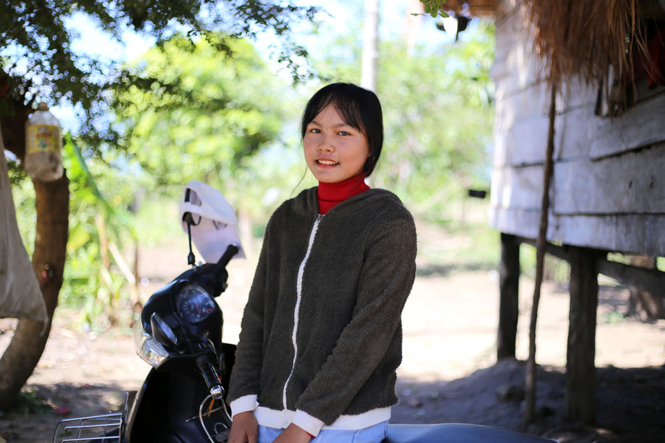 Girl and motorbike outside house